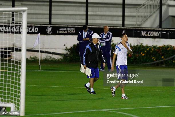Alejandro Sabella, coach of Argentina, and Angel Di Maria enter the field during a training session prior to the World Cup final match between...