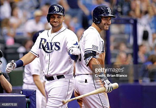 James Loney of the Tampa Bay Rays celebrates with teammate Kevin Kiermaier after scoring off of a bases-loaded walk of teammate Cole Figueroa during...