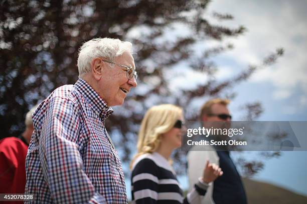 Warren Buffett , chairman of Berkshire Hathaway Inc., chats with other guests at the Allen & Company Sun Valley Conference at the Sun Valley Resort...