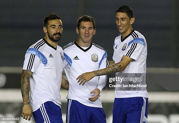 Ezequiel Lavezzi, Lionel Messi and Angel Di Maria of Argentina take part in a training session prior to the final match of the 2014 World Cup between...