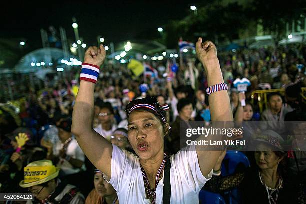 Anti-government protesters wave national flags during a rally at Democracy Monument on November 26, 2013 in Bangkok, Thailand. The Prime Minister of...