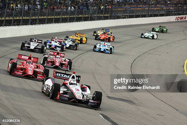 Helio Castroneves of Brazil, driver of the HItachi Team Penske Dallara Chevrolet, leads a pack of cars during the Iowa Corn Indy 300 at Iowa Speedway...