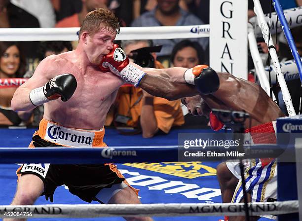 Erislandy Lara hits Canelo Alvarez in the fourth round of their junior middleweight bout at the MGM Grand Garden Arena on July 12, 2014 in Las Vegas,...