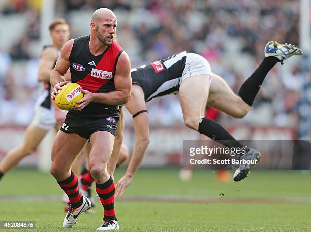 Paul Chapman of the Bombers beats the tackle of Nick Maxwell of the Magpies during the round 17 AFL match between the Essendon Bombers and the...