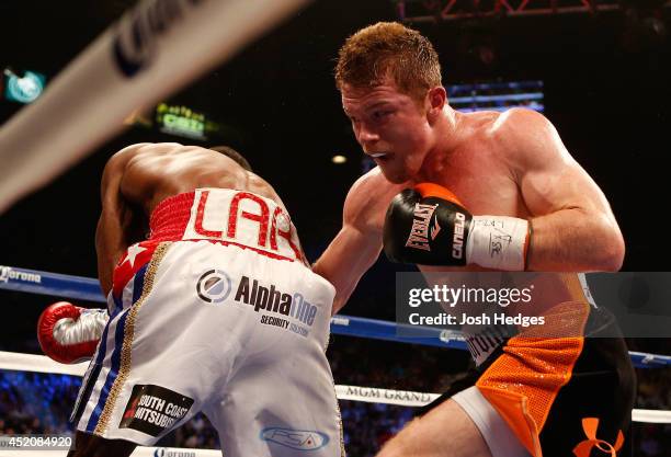 Canelo Alvarez digs a right to the body of Erislandy Lara during their junior middleweight bout at the MGM Grand Garden Arena on July 12, 2014 in Las...