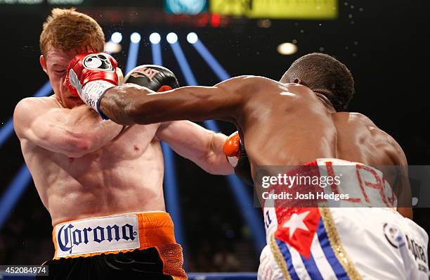 Erislandy Lara lands a left to the head of Canelo Alvarez during their junior middleweight bout at the MGM Grand Garden Arena on July 12, 2014 in Las...