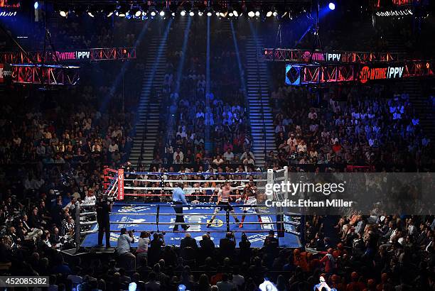 Referee Robert Byrd looks on as Canelo Alvarez hits Erislandy Lara in the third round of their junior middleweight bout at the MGM Grand Garden Arena...