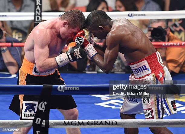 Canelo Alvarez and Erislandy Lara battle in the 12th round of their junior middleweight bout at the MGM Grand Garden Arena on July 12, 2014 in Las...