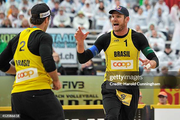 Alison Cerutti of Brazil celebrates a point with his teammate Bruno Oscar Schmidt during the mens main draw match Alison-Bruno v Erdmann-Matysik as...