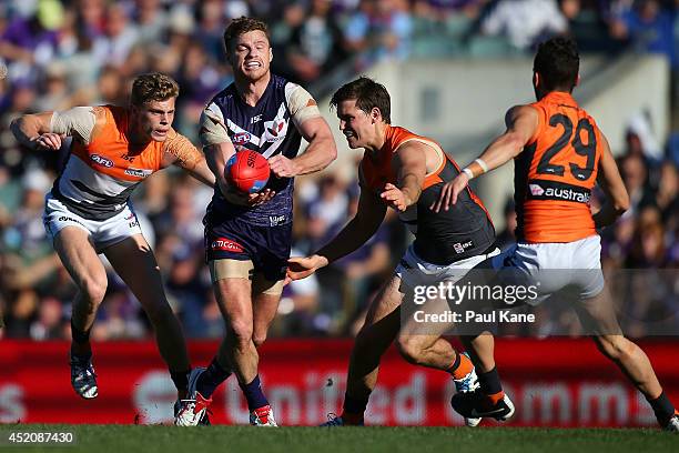 Colin Sylvia of the Dockers gets his handball away during the round 17 AFL match between the Fremantle Dockers and the Greater Western Sydney Giants...