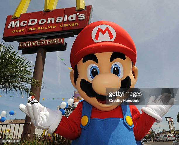 In this photo provided by Nintendo of America, Mario shows off one of the Mario Kart 8 themed Happy Meal toys at a McDonald's restaurant on July 12,...