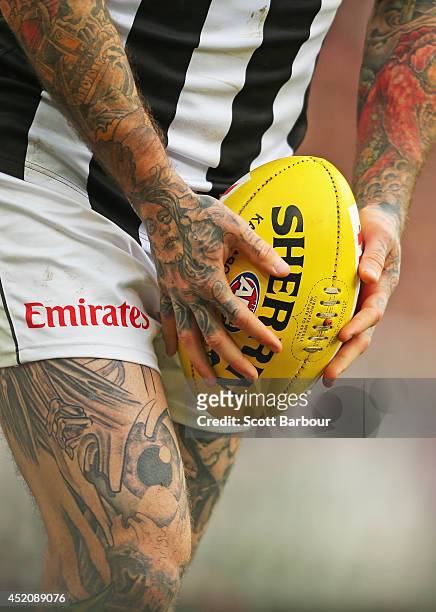 Detail of the tattoos of Dane Swan of the Magpies as he prepares to kick the ball the round 17 AFL match between the Essendon Bombers and the...