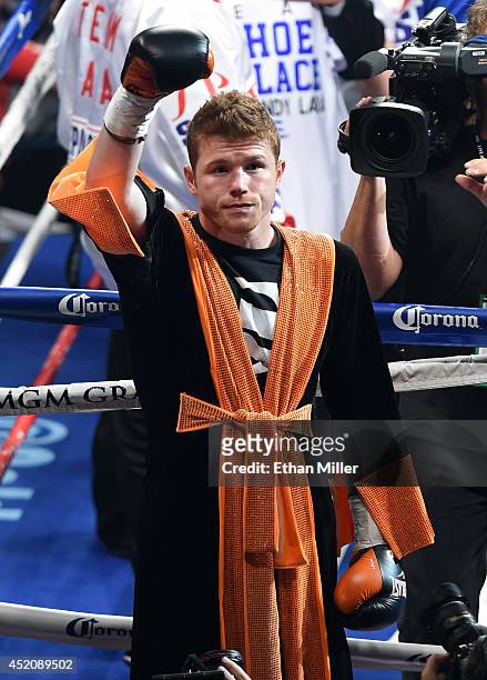 Canelo Alvarez gestures to the crowd as he enters the ring to take on Erislandy Lara in their junior middleweight bout at the MGM Grand Garden Arena...
