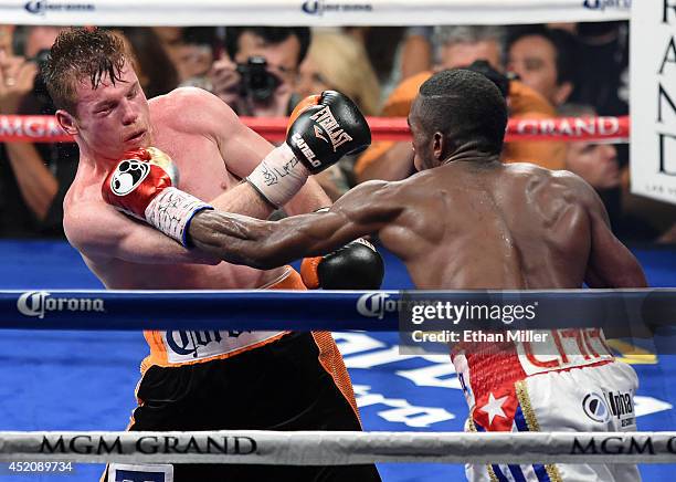Erislandy Lara throws a left at Canelo Alvarez in the 12th round of their junior middleweight bout at the MGM Grand Garden Arena on July 12, 2014 in...