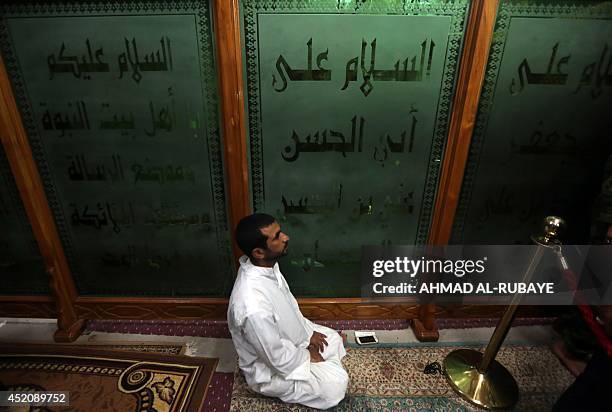 Shiites volunteers roam and pray inside the Al-Askari shrine which is under repair, and embraces the tombs of the 10th and 11th Imams, Ali Al-Hadi...