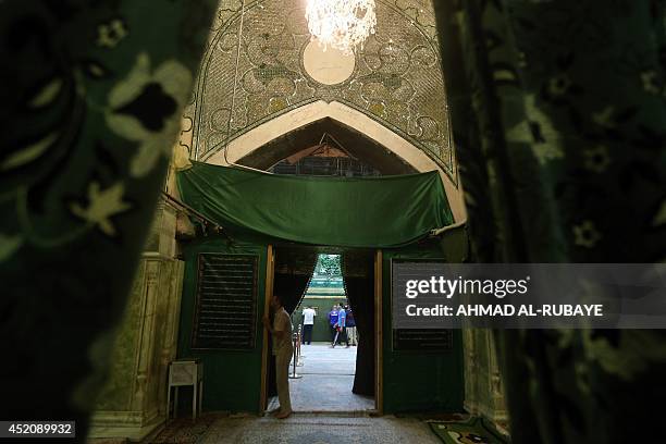 Shiites volunteers roam and pray inside the Al-Askari shrine which is under repair, and embraces the tombs of the 10th and 11th Imams, Ali Al-Hadi...