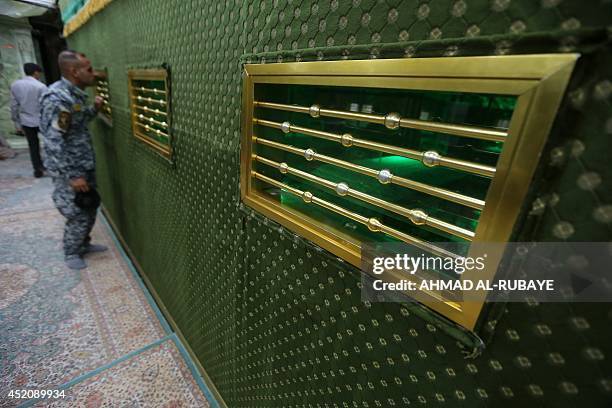 Shiites volunteers roam and pray inside the Al-Askari shrine which is under repair, and embraces the tombs of the 10th and 11th Imams, Ali Al-Hadi...