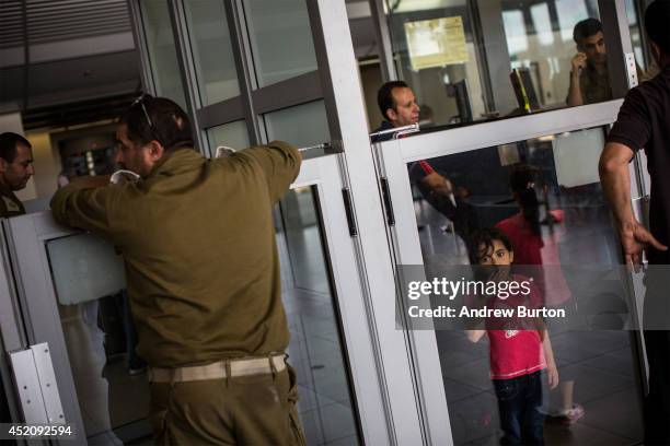 People wait to be let into Israel from Gaza during evacuations on the sixth day of Israel's operation 'Protective Edge' on July 12, 2014 in Erez,...
