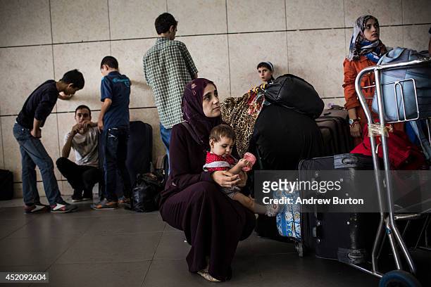 Family organizes themselves after crossing into Israel from Gaza at the Erez crossing point during evacuations on the sixth day of Israel's operation...