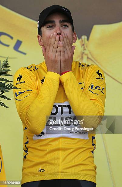 Tony Gallopin of France and Lotto Belisol takes the podium after claiming the overall race leader's jersey in stage nine of the 2014 Le Tour de...