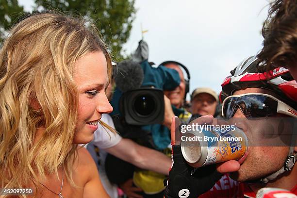 Tony Gallopin of France and Team Lotto Belisol is congratulated by his girlfriend Marion Rousse after securing the yellow jersey and race lead on the...