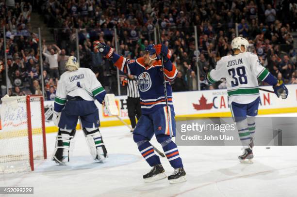 Nail Yakupov of the Edmonton Oilers celebrates his first hat trick as Roberto Luongo and Derek Joslin of the Vancouver Canucks turn their backs in...