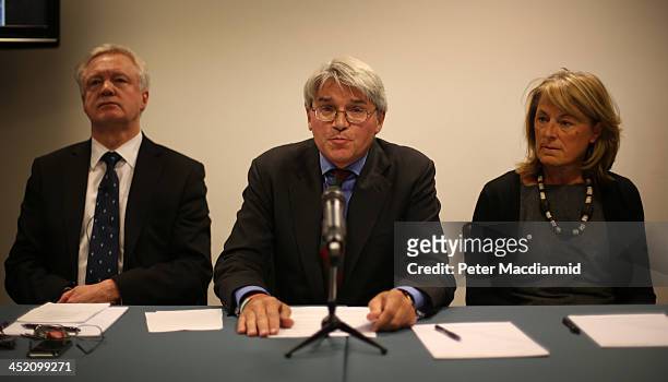 Former Chief Whip Andrew Mitchell is supported by his wife Dr Sharon Bennett and David Davies as he speaks to reporters on November 26, 2013 in...