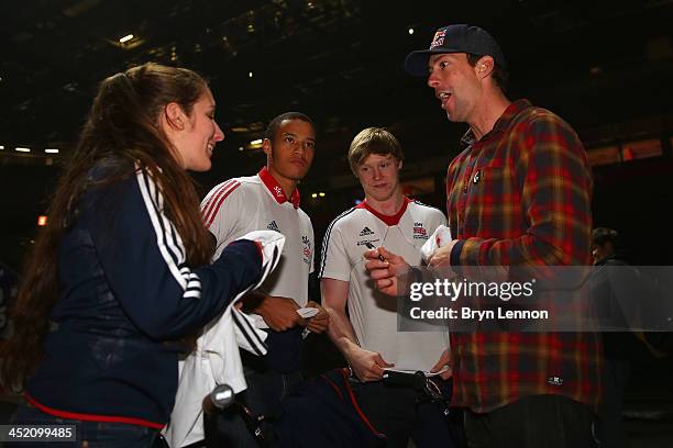 Games gold medalist Travis Pastrana signs autographs for Abby Taylor of British Cyclng prior to the Nitro Circus Live Show at the MEN Arena on...