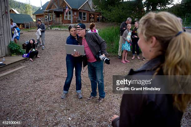 Mikaela Shiffrin watches photographers Brent and Barbara Bingham review images during a portrait session on July 15, 2013.