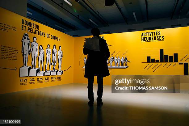 Person looks at an artwork by Austrian-born artist Stefan Sagmeister during the press presentation of the exhibition ''The Happy Show'', on November...