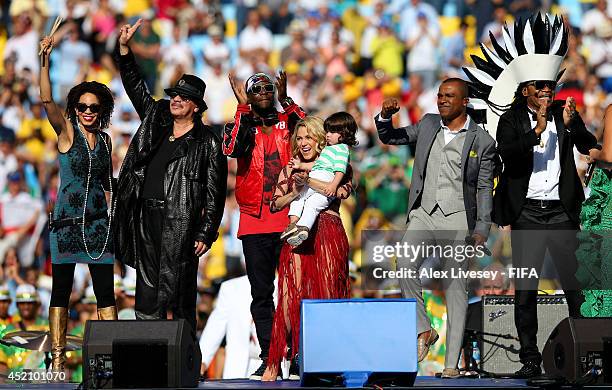 Musicians Carlos Santana, Wyclef Jean, Shakira, her son Milan, Alexandre Pires and Carlinhos Brown are seen on stage during the closing ceremony...