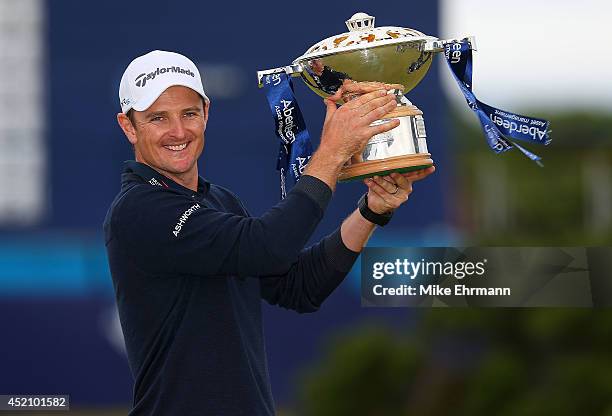 Justin Rose of England poses with the trophy after winning the 2014 Aberdeen Asset Management Scottish Open at Royal Aberdeen Golf Club on July 13,...