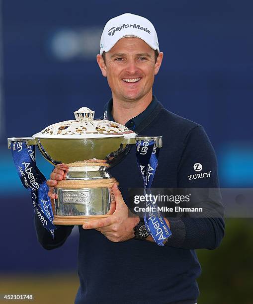 Justin Rose of England poses with the trophy after winning the 2014 Aberdeen Asset Management Scottish Open at Royal Aberdeen Golf Club on July 13,...