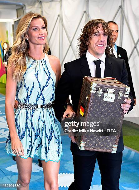 Former Spanish international Carles Puyol and model Gisele Bundchen walk in the tunnel to present the World Cup in a Louis Vuitton travel case prior...