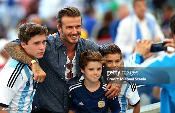 Former England international David Beckham and sons Brooklyn Beckham , Cruz Beckham and Romeo Beckham prior to the 2014 FIFA World Cup Brazil Final...