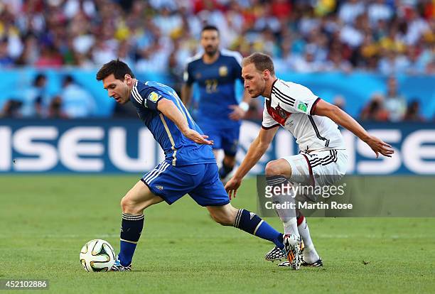 Lionel Messi of Argentina controls the ball against Benedikt Hoewedes of Germany during the 2014 FIFA World Cup Brazil Final match between Germany...