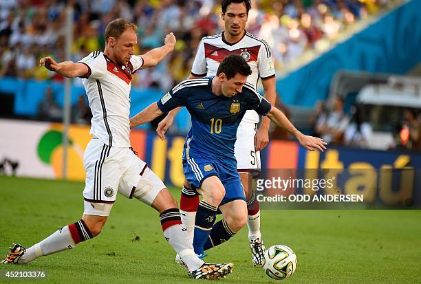 Germany's defender Benedikt Hoewedes vies with Argentina's forward Lionel Messi during the final football match between Germany and Argentina for the...