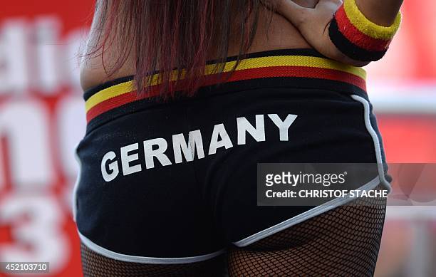 German fan in hot pants watches the FIFA World Cup 2014 final football match Germany vs Argentina played in Brazil during an outdoor viewing at the...