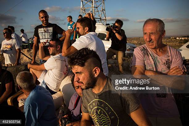 Civilians and members of the media wait to see Israeli attacks inside Gaza from the top of a hill on the sixth day of Israel's operation 'Protective...