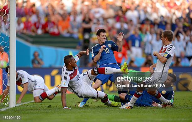 Lionel Messi of Argentina competes for the ball against Jerome Boateng and Philipp Lahm of Germany during the 2014 FIFA World Cup Brazil Final match...