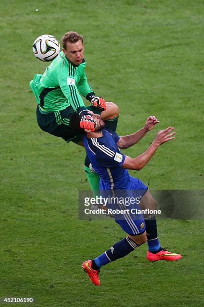 Goalkeeper Manuel Neuer of Germany collides with Gonzalo Higuain of Argentina during the 2014 FIFA World Cup Brazil Final match between Germany and...