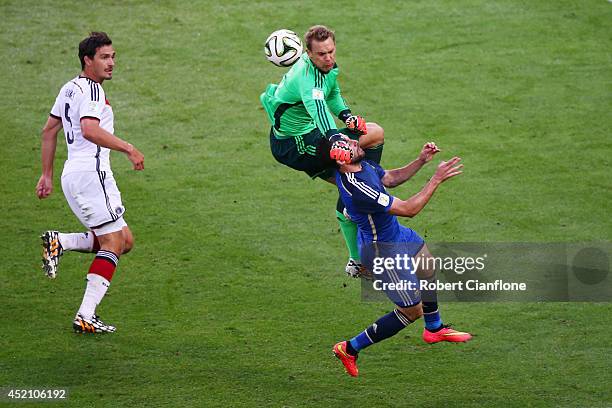 Goalkeeper Manuel Neuer of Germany collides with Gonzalo Higuain of Argentina during the 2014 FIFA World Cup Brazil Final match between Germany and...