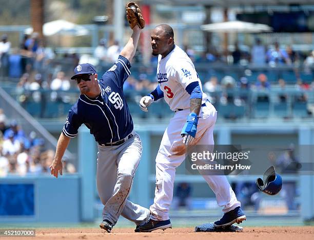 Brooks Conrad of the San Diego Padres and Carl Crawford of the Los Angeles Dodgers react to a stolen base during the first inning at Dodger Stadium...