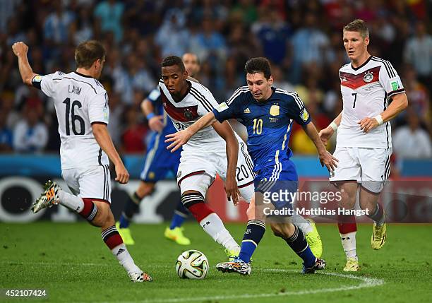 Lionel Messi of Argentina takes on Philipp Lahm and Jerome Boateng Germany during the 2014 FIFA World Cup Brazil Final match between Germany and...