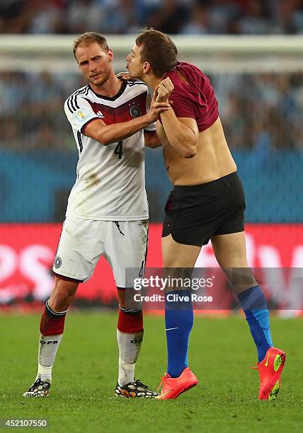 Pitch invader tries to kiss Benedikt Hoewedes of Germany during the 2014 FIFA World Cup Brazil Final match between Germany and Argentina at Maracana...