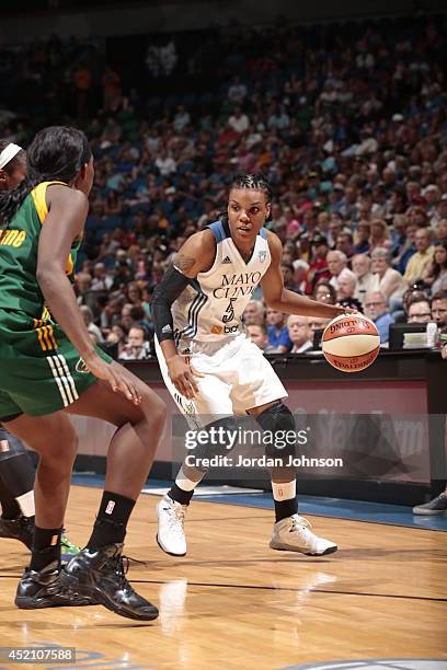 Tan White of the Minnesota Lynx drives to the basket against the Seattle Storm during the WNBA game on July 13, 2014 at Target Center in Minneapolis,...