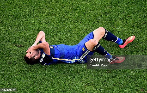 Gonzalo Higuain of Argentina lies on the pitch after a collision during the 2014 FIFA World Cup Brazil Final match between Germany and Argentina at...