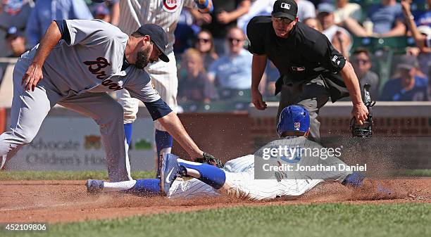 Starlin Castro of the Chicago Cubs is tagged out at the plate by Jordan Walden of the Atlanta Braves in the 8th inning at Wrigley Field on July 13,...