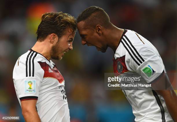Mario Goetze of Germany celebrates scoring his team's first goal with Jerome Boateng during the 2014 FIFA World Cup Brazil Final match between...