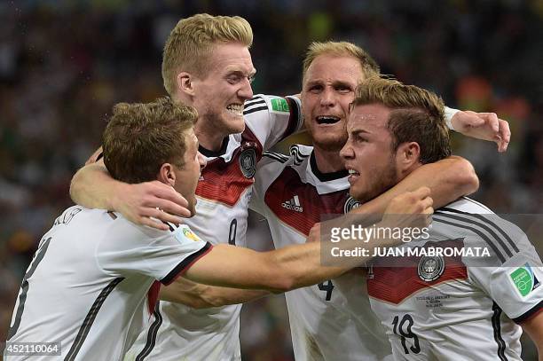 Germany's forward Mario Goetze celebrates with his teammates Germany's forward Thomas Mueller , Germany's forward Andre Schuerrle and Germany's...